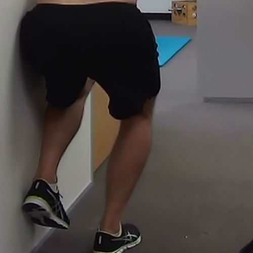 One leg wall squat demonstration
